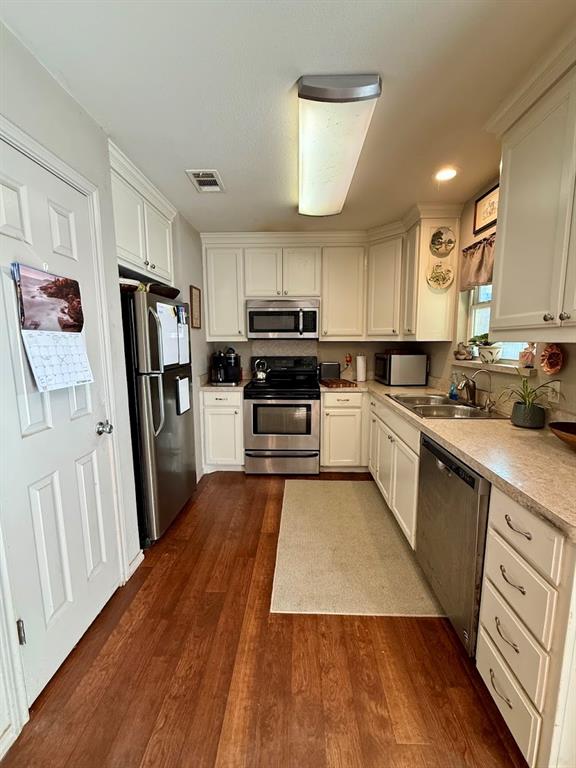 2001 Wood Trail Azle, TX 76020 - Photo 17 of 30 a kitchen with wooden floors appliances a sink and cabinets