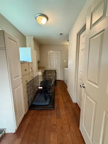 a kitchen with sink a refrigerator and wooden floor
