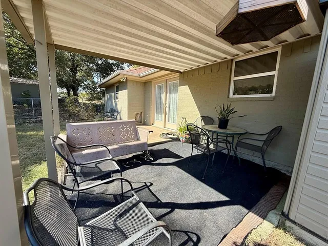 a backyard of a house with outdoor seating