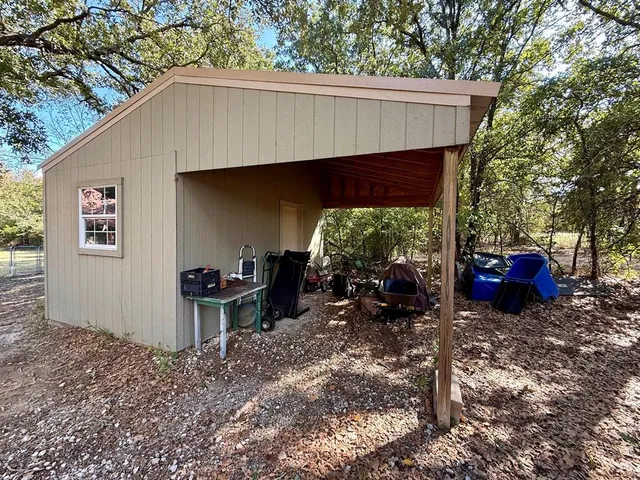 a view of a house with a yard chairs and a stove