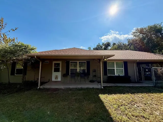 a view of a house with a small yard and a garden
