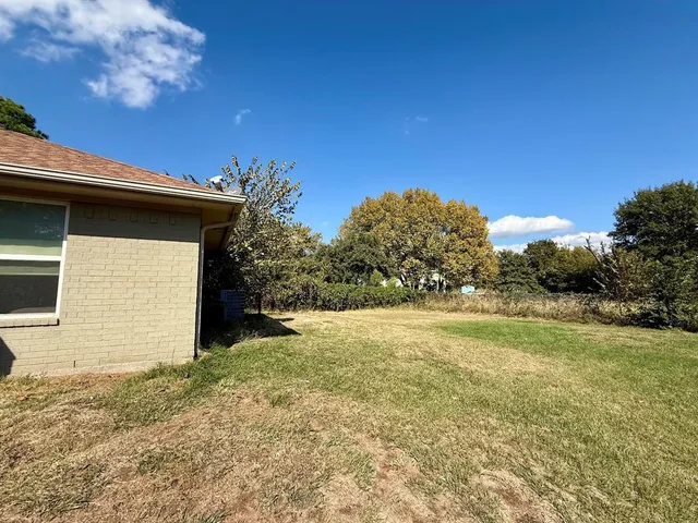 a view of a backyard of the house