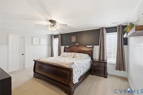 a bedroom with bed and a tv