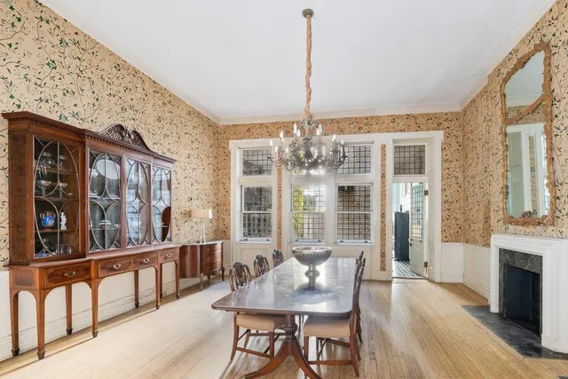 a living room with furniture a chandelier and a fireplace