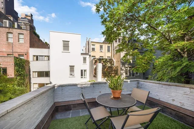 a spacious bedroom with a bed and a flat screen tv