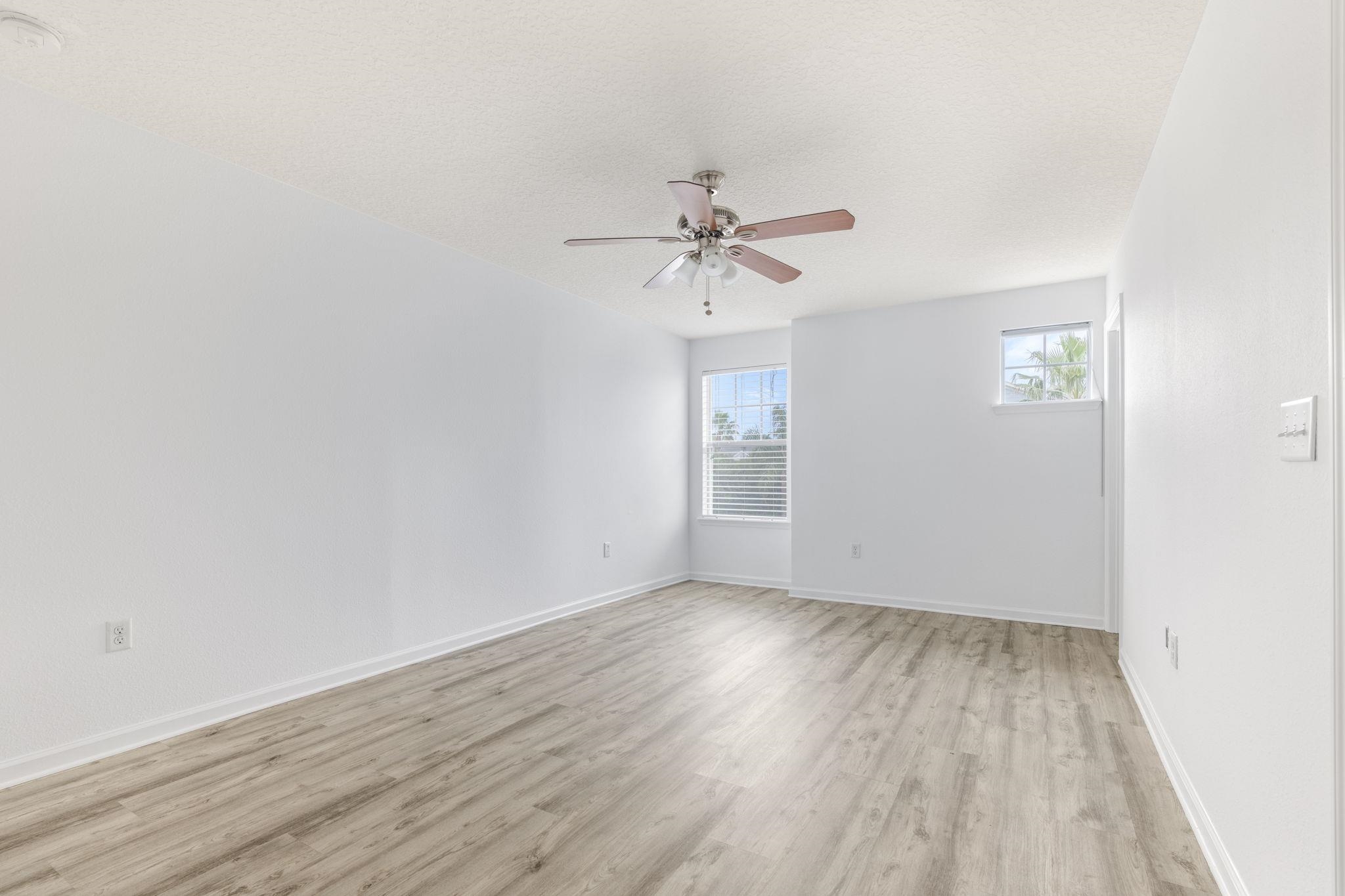 128 Islander Circle St. Augustine, FL 32080 - Photo 11 of 24 wooden floor in an empty room with a window