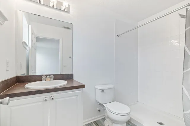 a bathroom with a sink toilet and a mirror