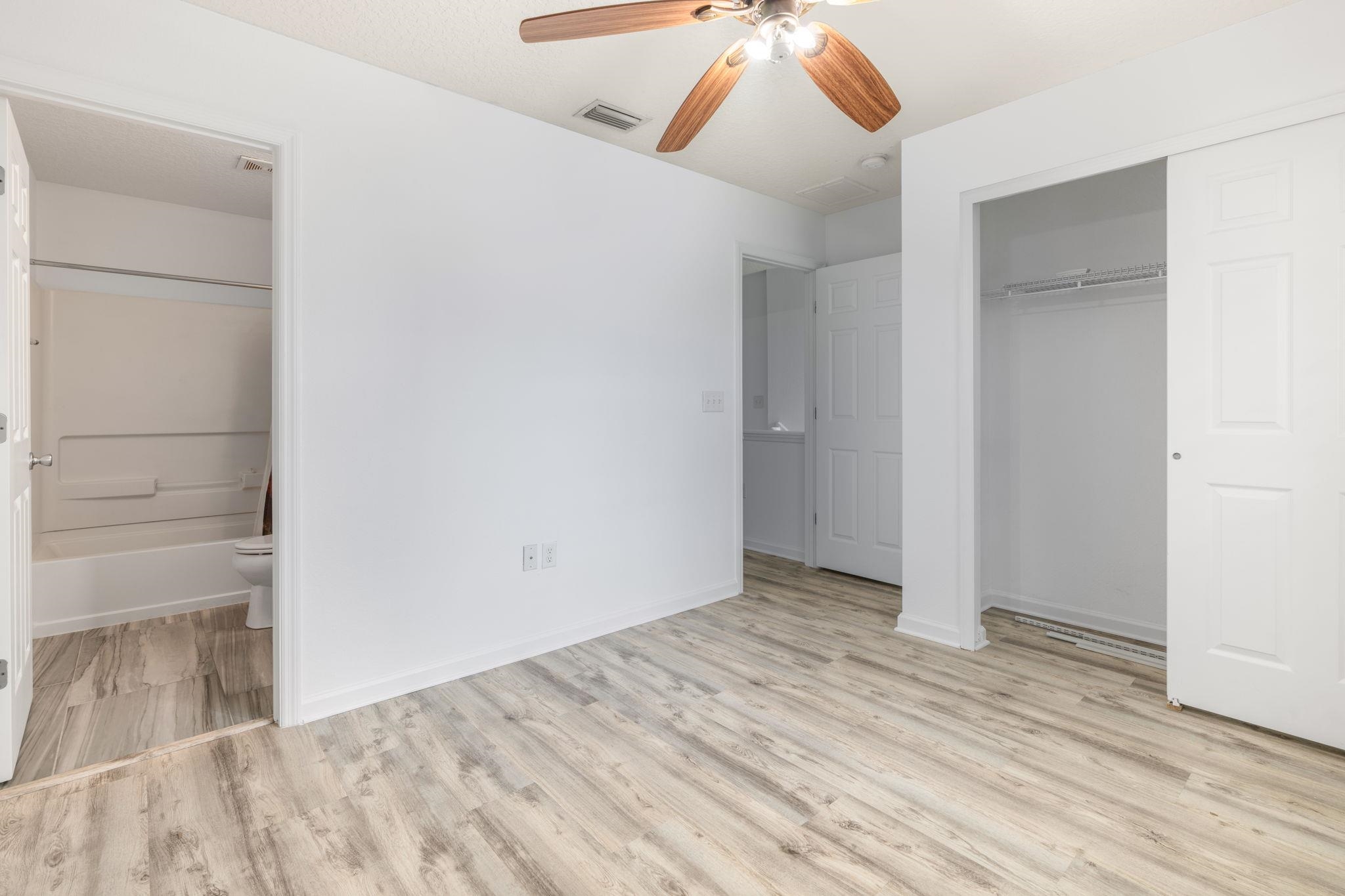 128 Islander Circle St. Augustine, FL 32080 - Photo 15 of 24 an empty room with wooden floor closet and chandelier fan
