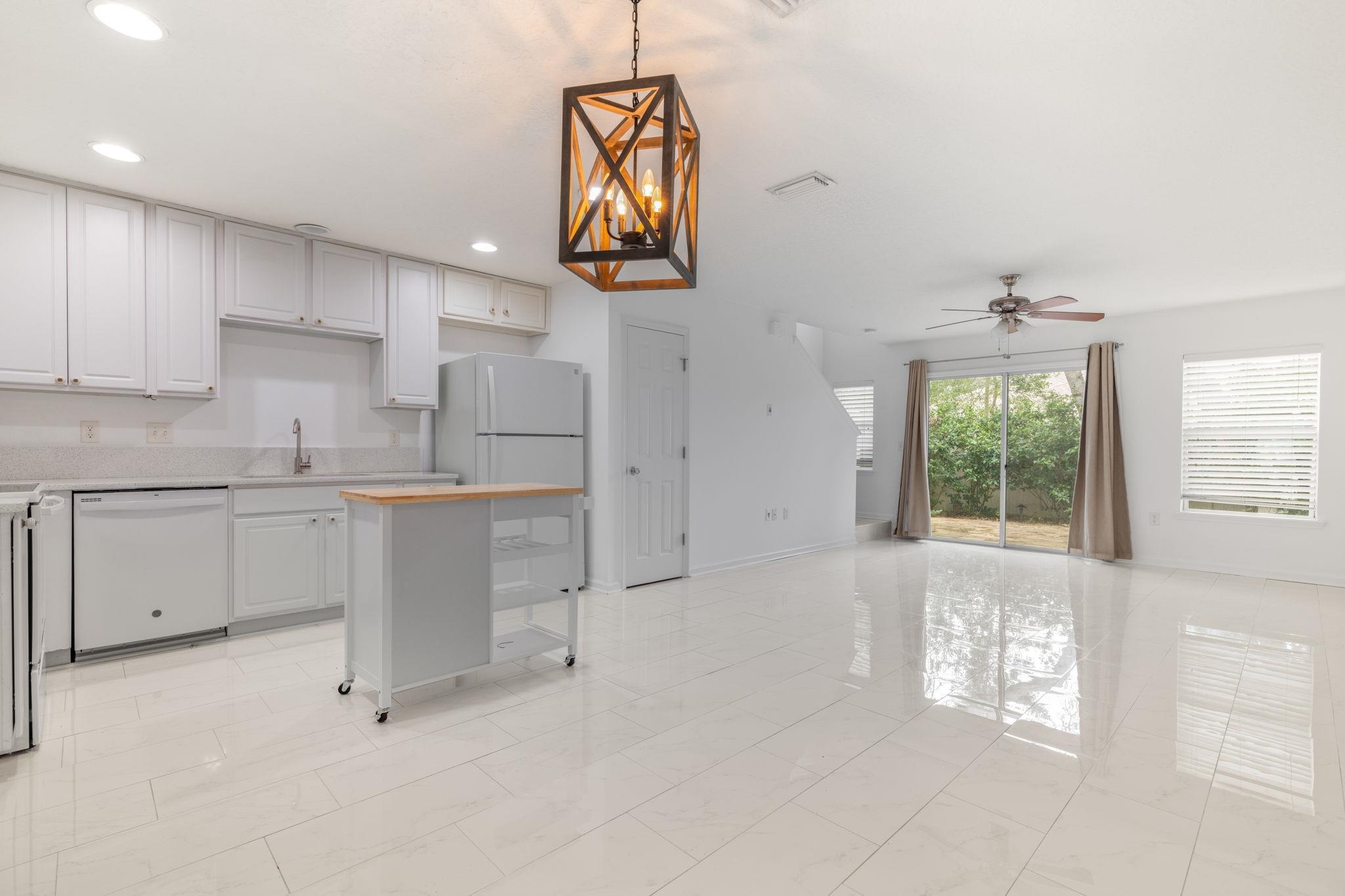 128 Islander Circle St. Augustine, FL 32080 - Photo 5 of 24 a kitchen with white cabinets and window