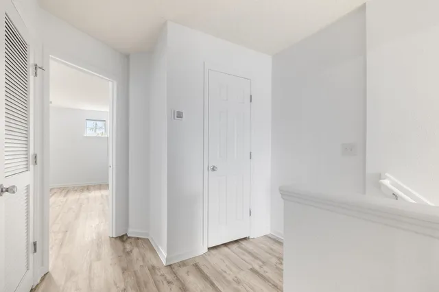 a view of hallway with wooden floor