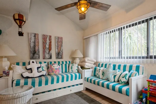 a bedroom with furniture and a large window