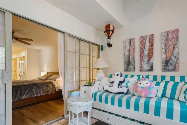 a bedroom with a bed a couch and a painting on the wall