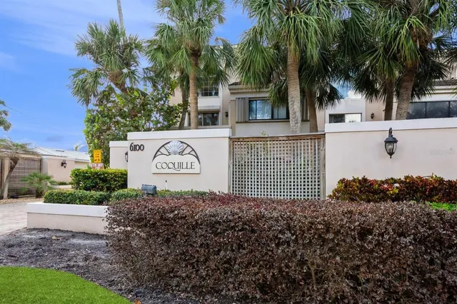 a sign board with a house in front of it