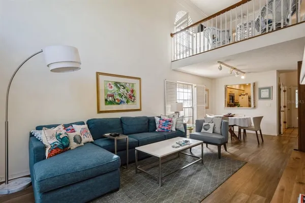 a living room with furniture a rug and a window