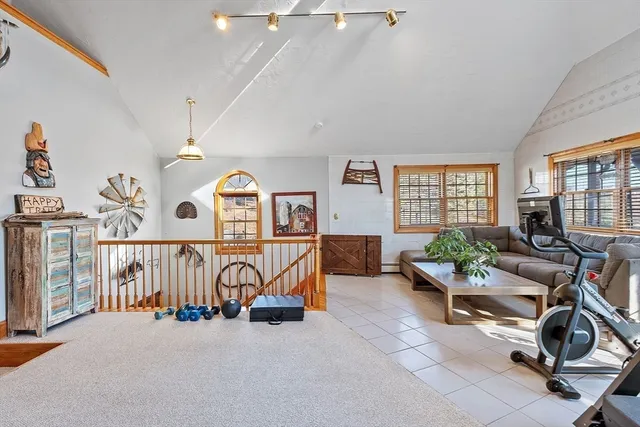 a bathroom with a sink mirror toilet and next to a window