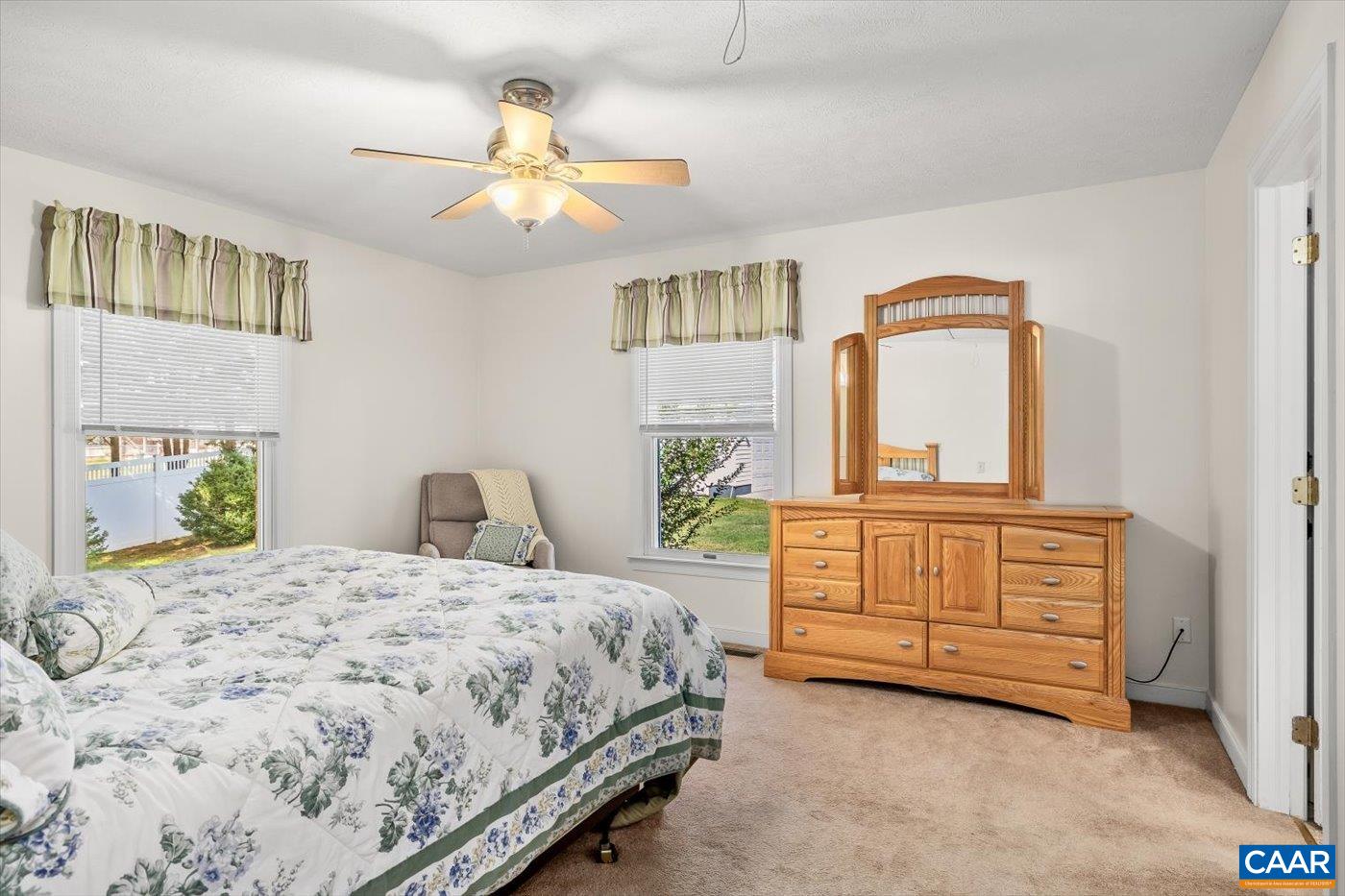 6134 Spring Hill Road Ruckersville, VA 22968 - Photo 36 of 54 a bedroom with a bed a dresser and potted plants