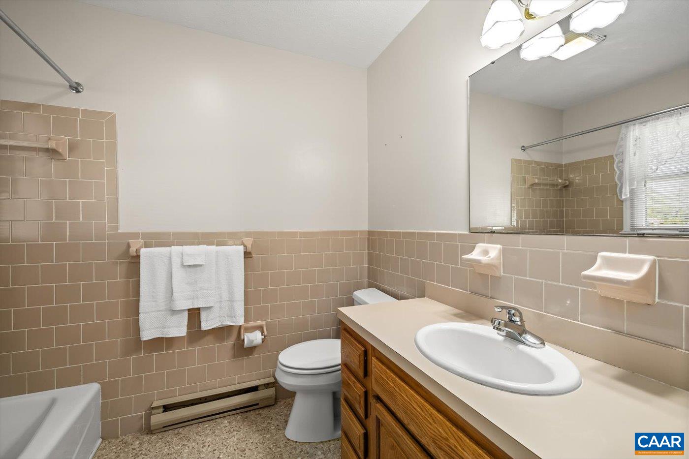 6134 Spring Hill Road Ruckersville, VA 22968 - Photo 38 of 54 a bathroom with a sink a toilet and mirror