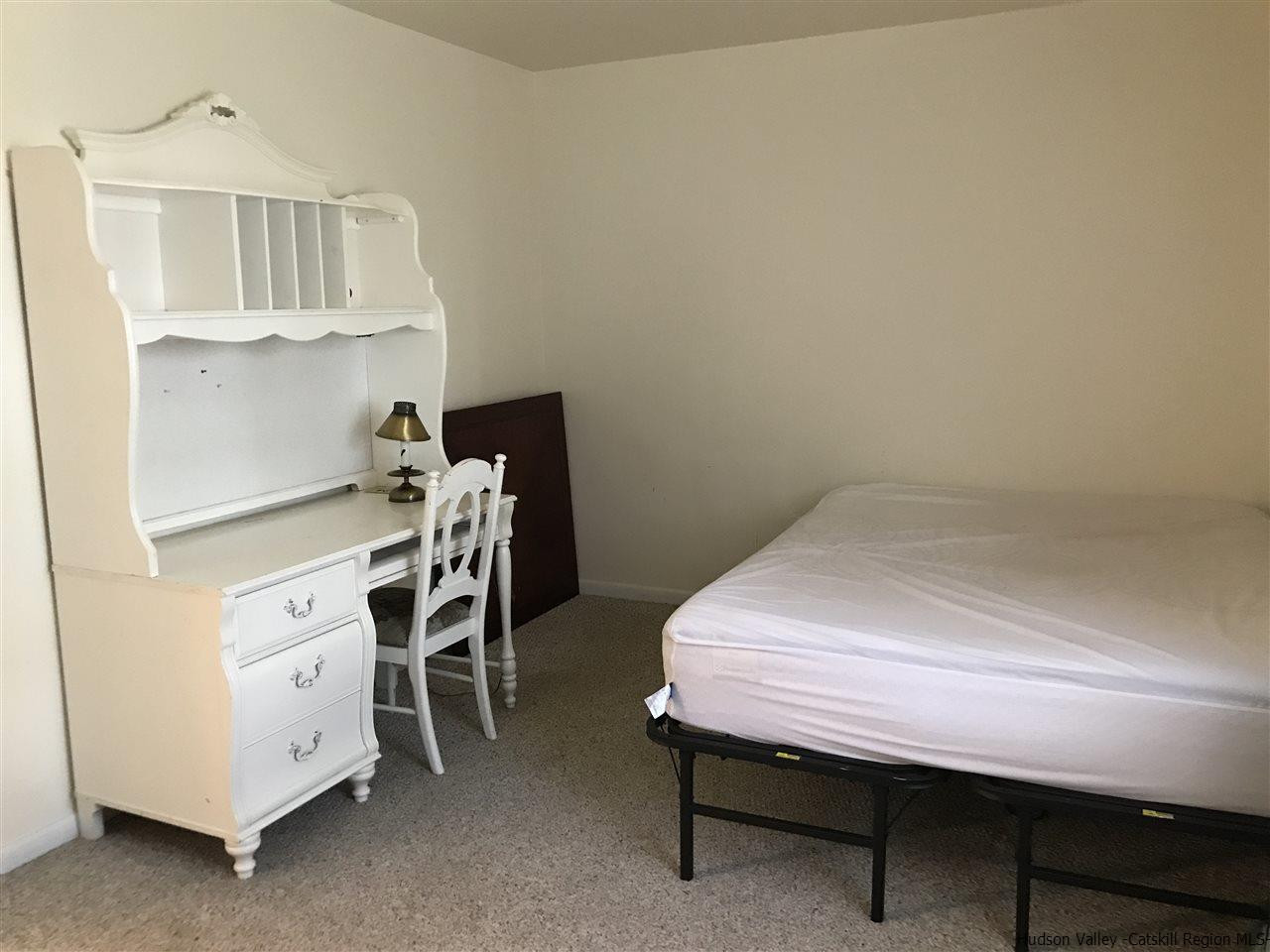 2740 South Road, Unit G7 Poughkeepsie, NY 12601 - Photo 12 of 12 a bed room with a bed and a table