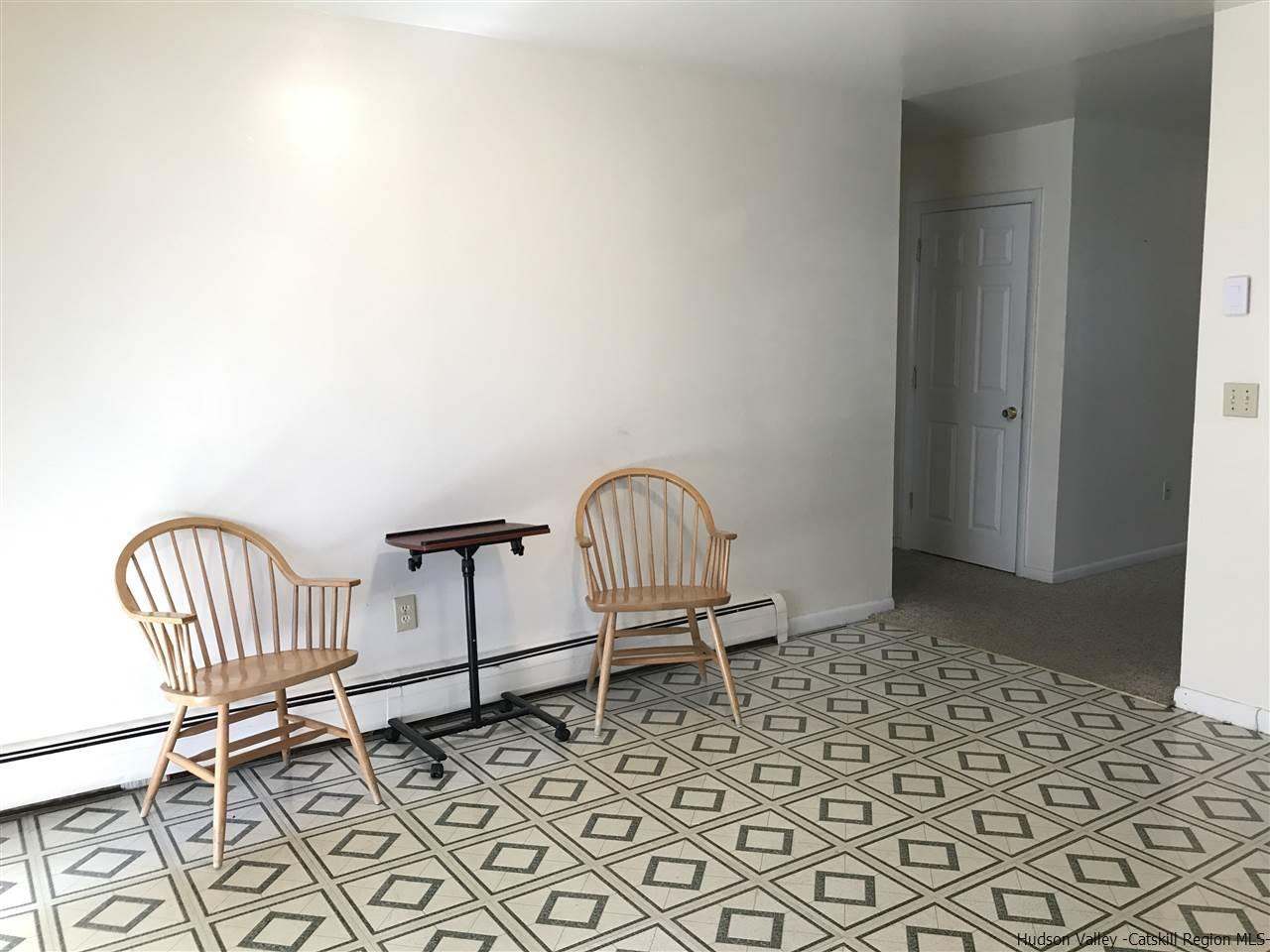 2740 South Road, Unit G7 Poughkeepsie, NY 12601 - Photo 6 of 12 a view of a room with wooden floor and chairs