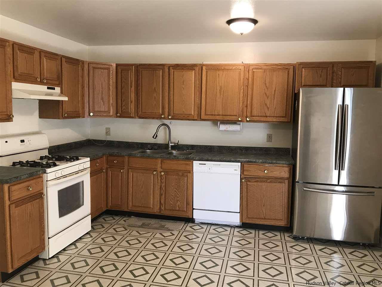 2740 South Road, Unit G7 Poughkeepsie, NY 12601 - Photo 7 of 12 a kitchen with a sink a stove and cabinets