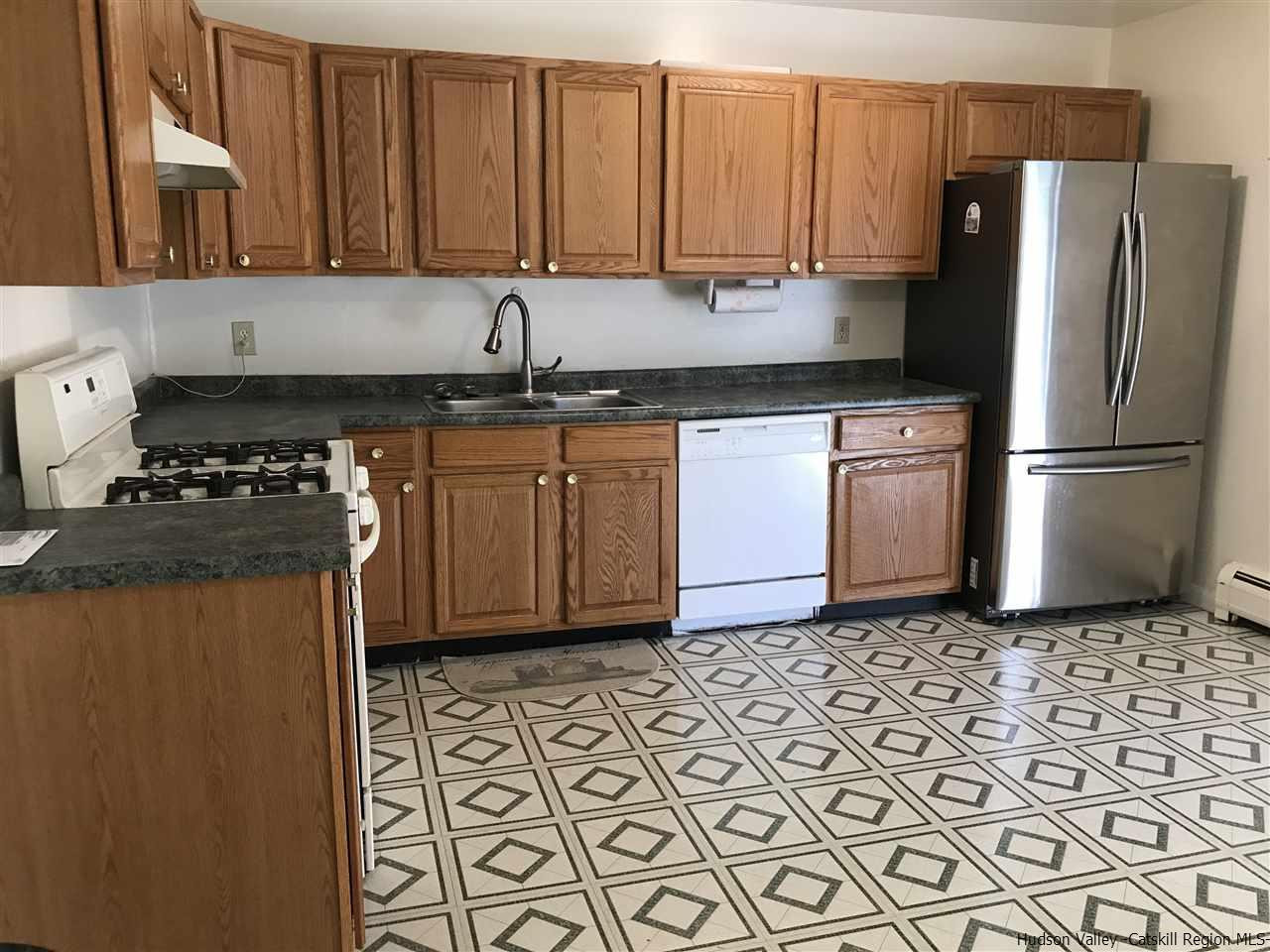 2740 South Road, Unit G7 Poughkeepsie, NY 12601 - Photo 8 of 12 a kitchen with a refrigerator sink and cabinets