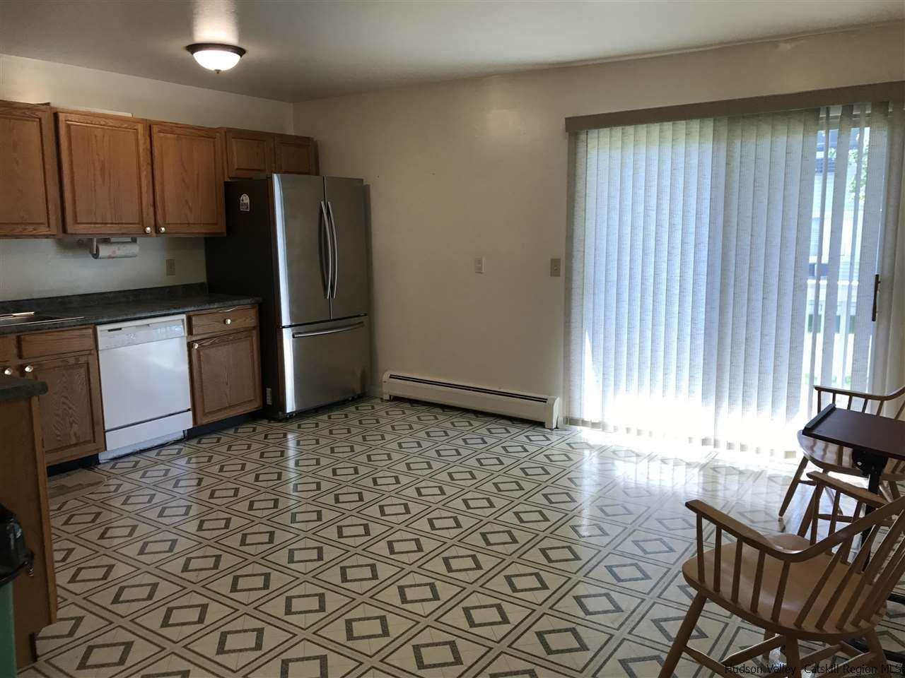 2740 South Road, Unit G7 Poughkeepsie, NY 12601 - Photo 9 of 12 a kitchen with stainless steel appliances a refrigerator sink and microwave