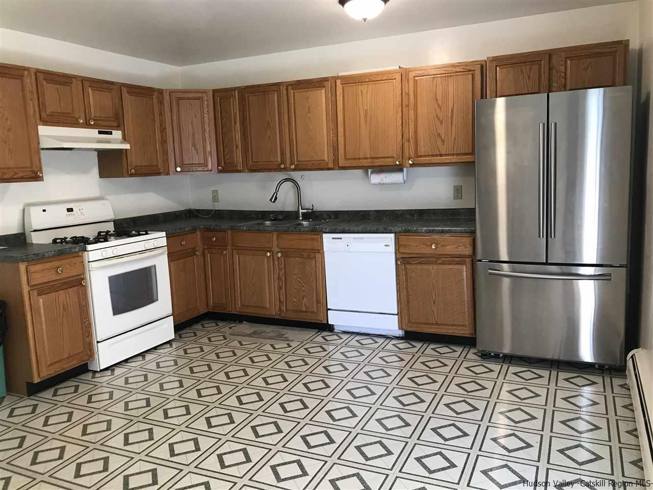 2740 South Road, Unit G7 Poughkeepsie, NY 12601 - Photo 10 of 12 a kitchen with stainless steel appliances granite countertop a refrigerator sink and cabinets