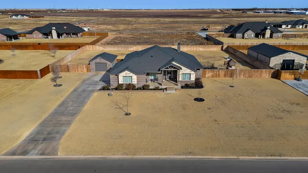 an aerial view of a house with outdoor space