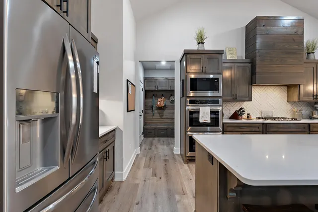 a large kitchen with a table and chairs