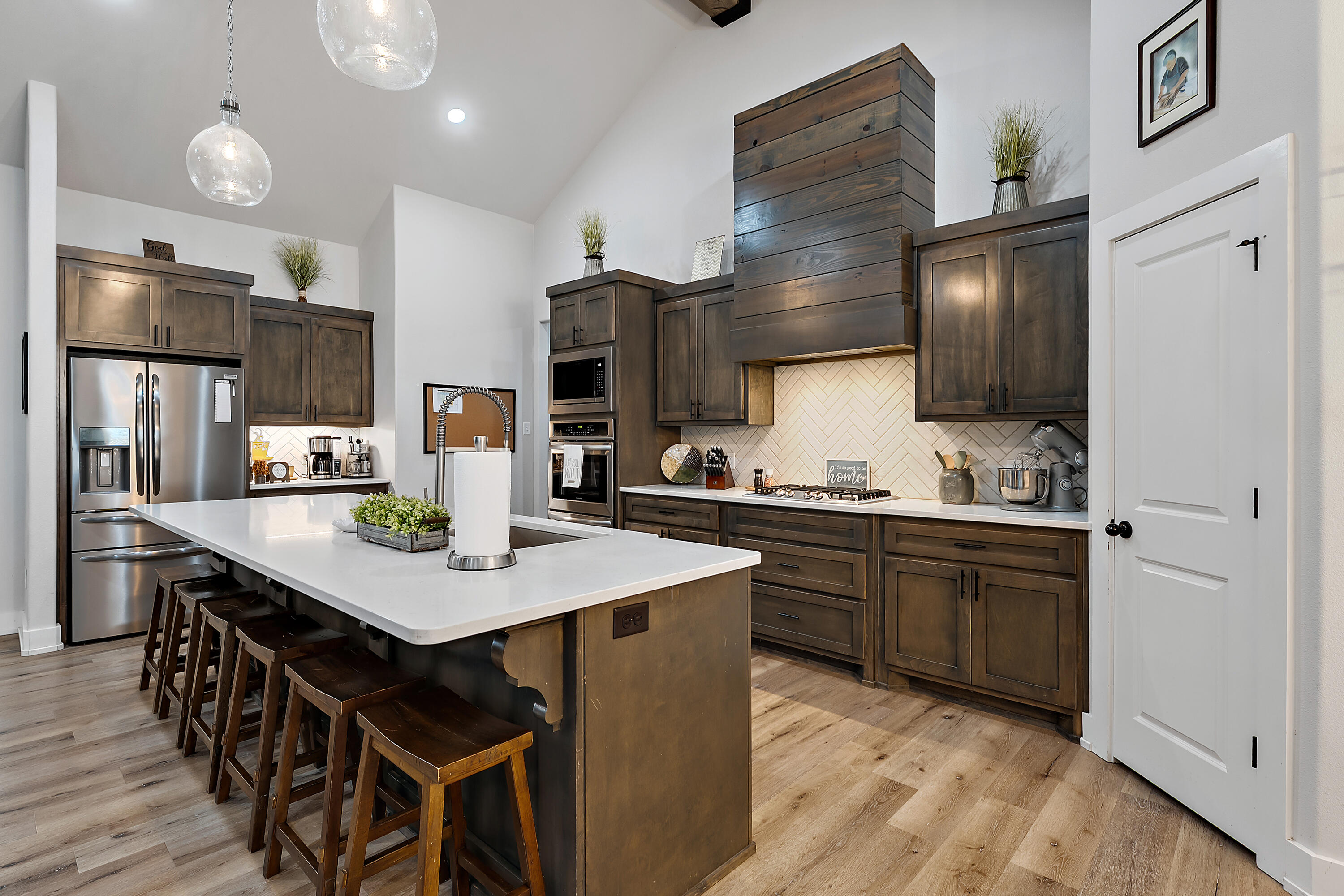 9218 County Road 6870 Lubbock, TX 79407 - Photo 16 of 45 a kitchen with stainless steel appliances granite countertop a table chairs sink refrigerator and microwave
