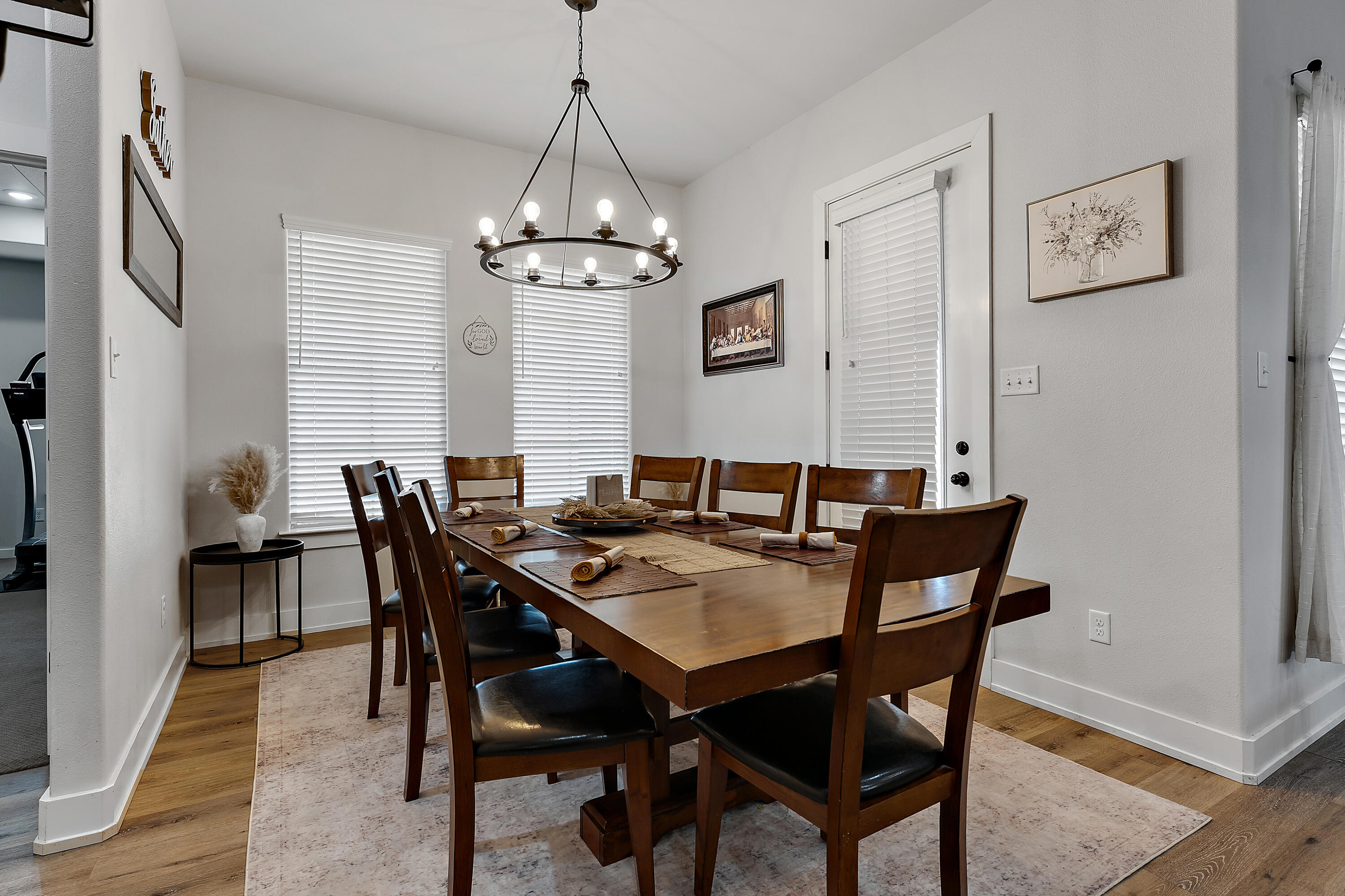 9218 County Road 6870 Lubbock, TX 79407 - Photo 17 of 45 a view of a dining room with furniture wooden floor and a chandelier