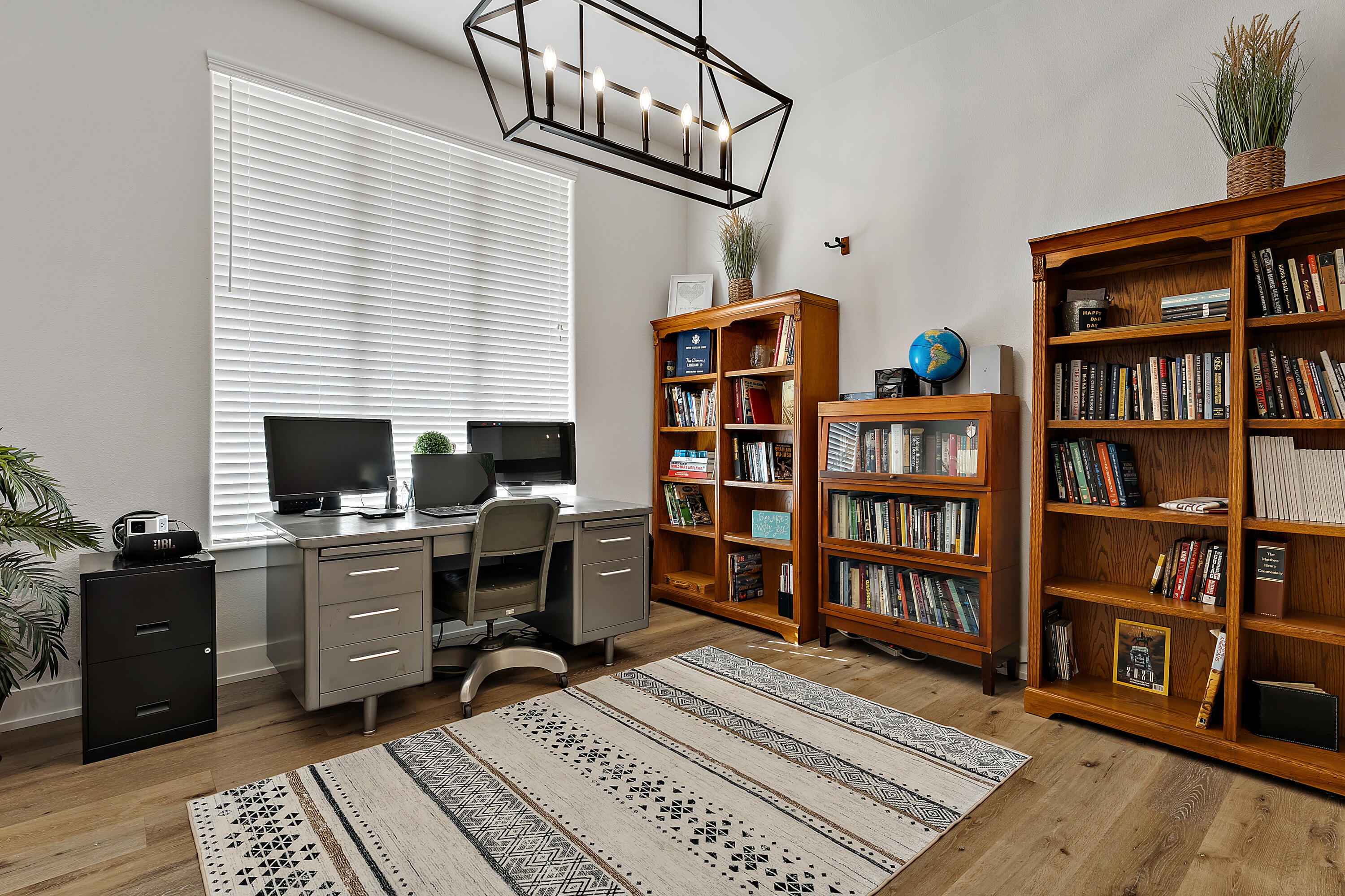 9218 County Road 6870 Lubbock, TX 79407 - Photo 18 of 45 a view of a workspace with bookshelf and a window