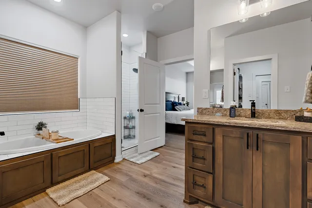 a bathroom with a double vanity sink a mirror and shower