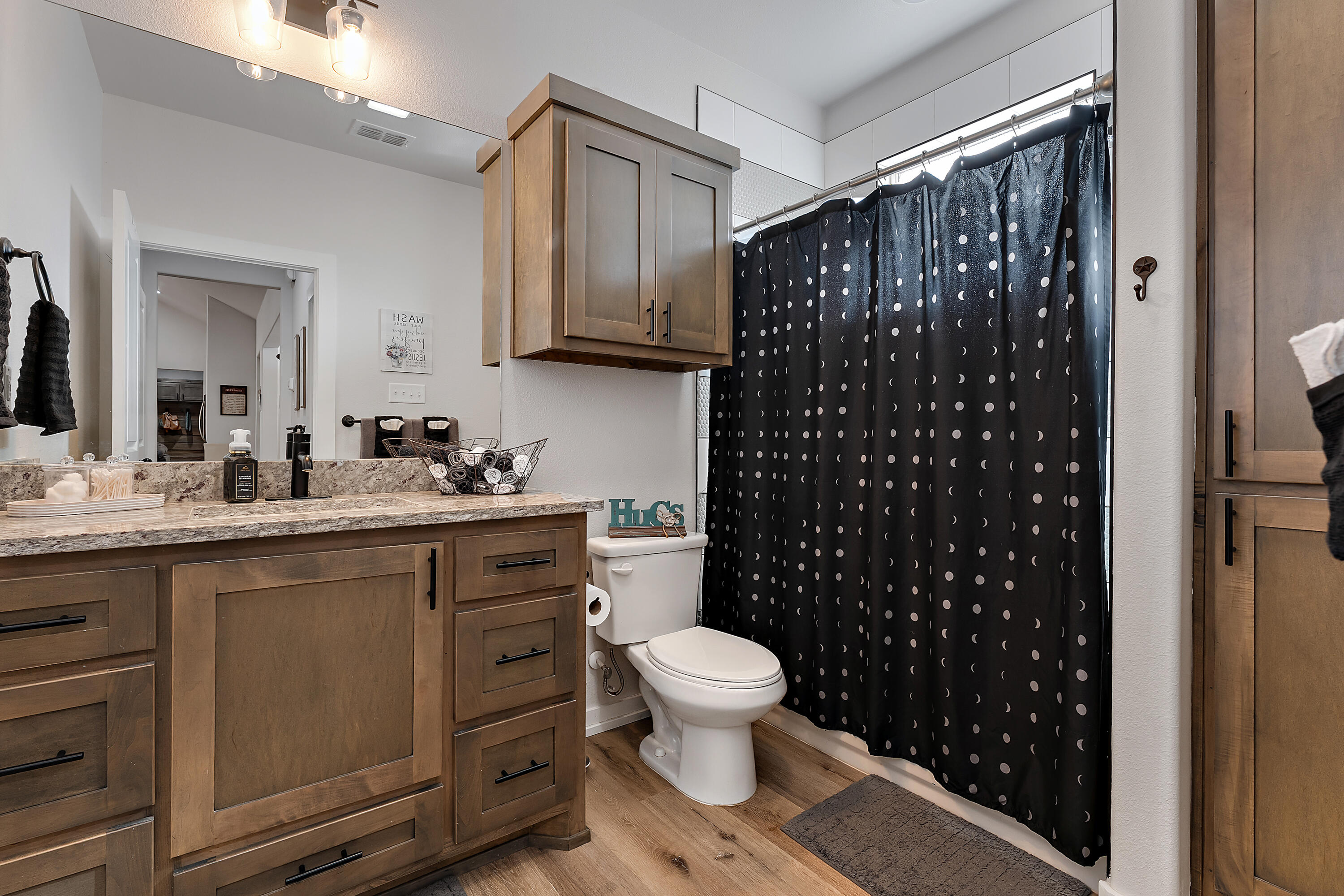 9218 County Road 6870 Lubbock, TX 79407 - Photo 31 of 45 a bathroom with a granite countertop sink toilet and shower