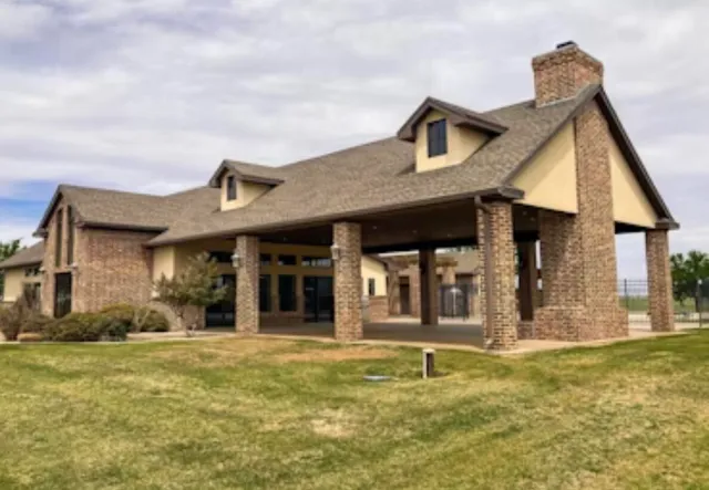 a front view of a residential apartment building with a yard