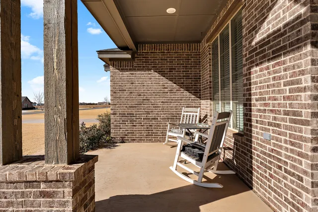 a view of an entryway with wooden floor and a fireplace
