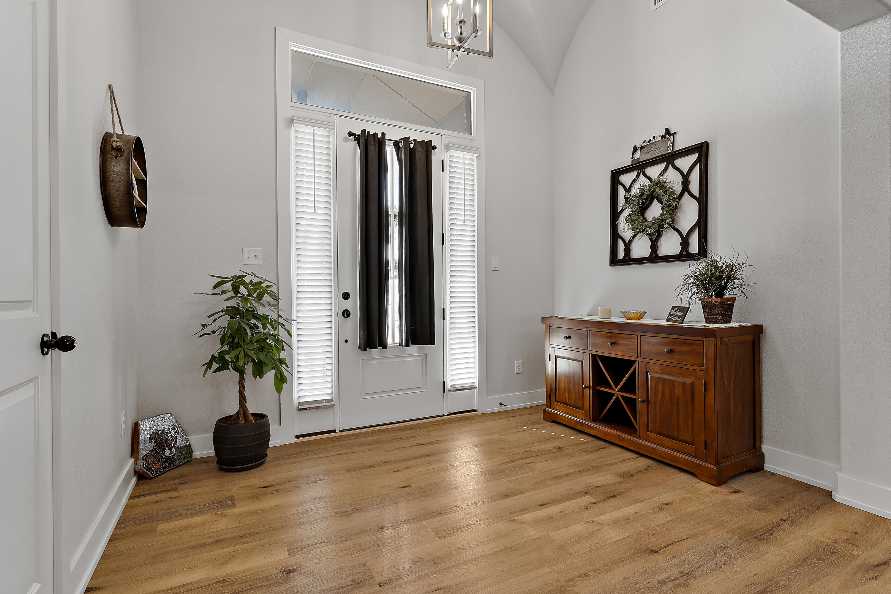9218 County Road 6870 Lubbock, TX 79407 - Photo 7 of 45 a view of an entryway with wooden floor and a fireplace