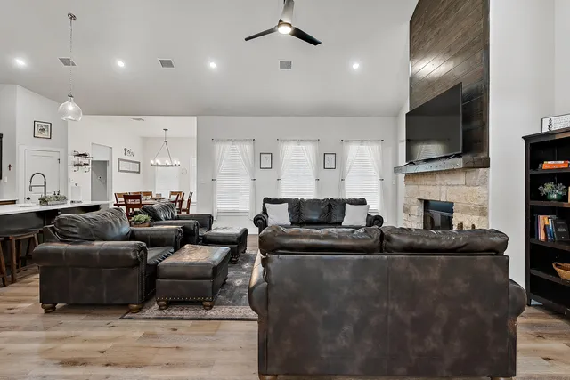 a living room with furniture fireplace and a flat screen tv