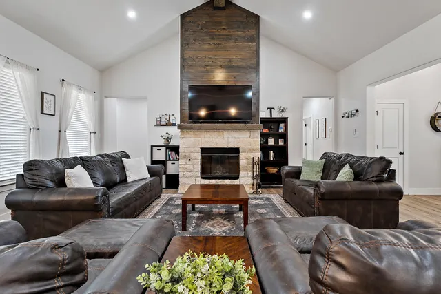 a living room with furniture flat screen tv and a fireplace