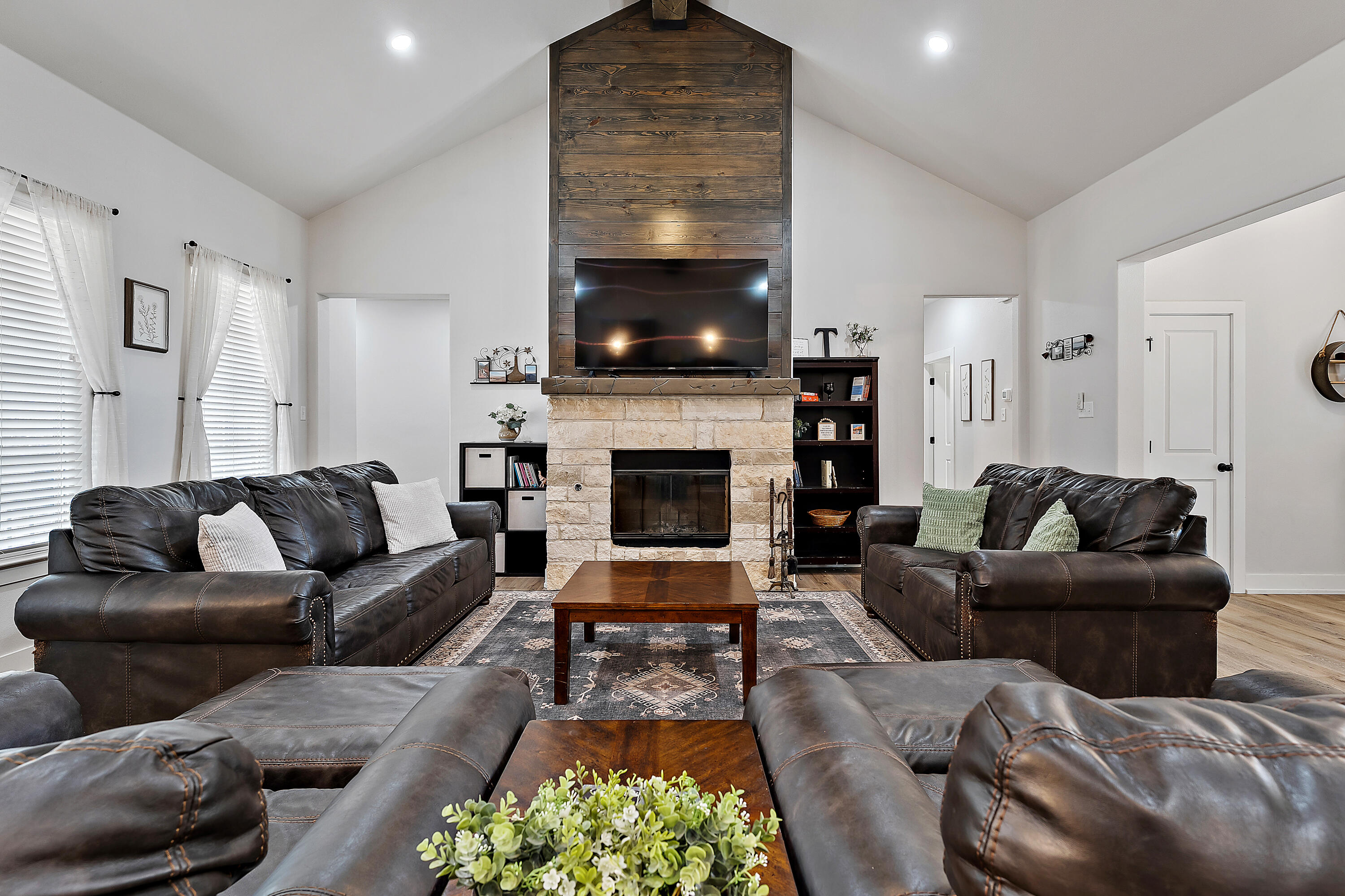 9218 County Road 6870 Lubbock, TX 79407 - Photo 10 of 45 a living room with furniture a flat screen tv and a fireplace