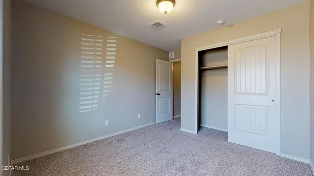 a bathroom with a granite countertop sink a mirror and shower