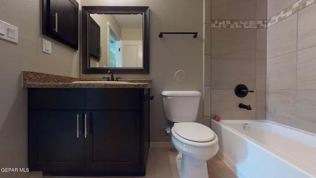 an empty room with ceiling fan and window