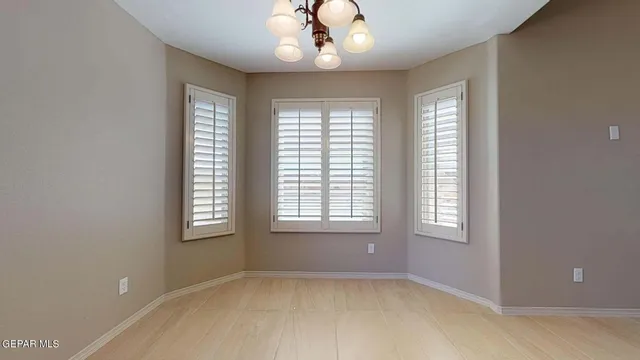 a kitchen with granite countertop window and cabinets