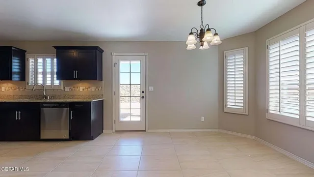 a view of kitchen with cabinets microwave and refrigerator