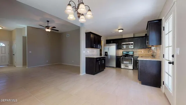 a large kitchen with stainless steel appliances kitchen island granite countertop a sink counter space and stainless steel appliances