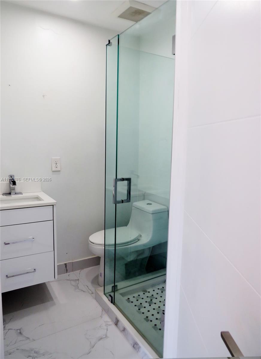 16330 Southwest 102nd Street Miami, FL 33196 - Photo 12 of 30 a bathroom with a sink toilet and shower