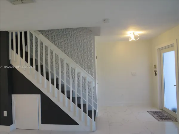 a view of entryway with wooden floor