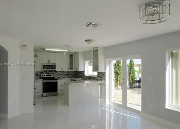 a kitchen with stainless steel appliances granite countertop a stove and a refrigerator