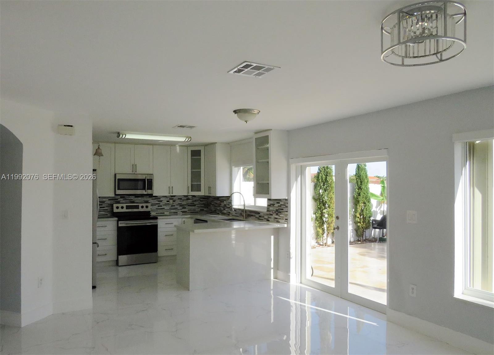 16330 Southwest 102nd Street Miami, FL 33196 - Photo 6 of 30 a kitchen with stainless steel appliances granite countertop a stove and a refrigerator