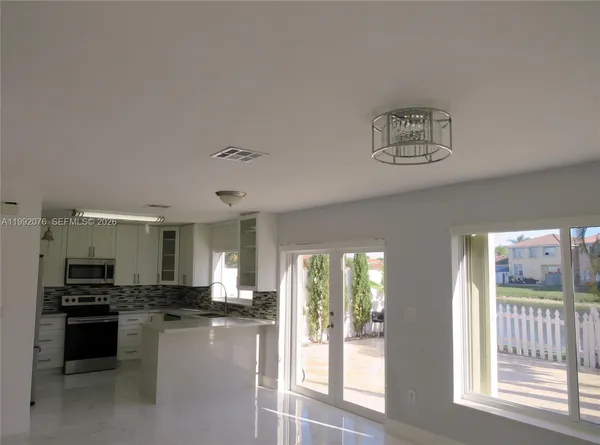 a kitchen with a refrigerator and a sink